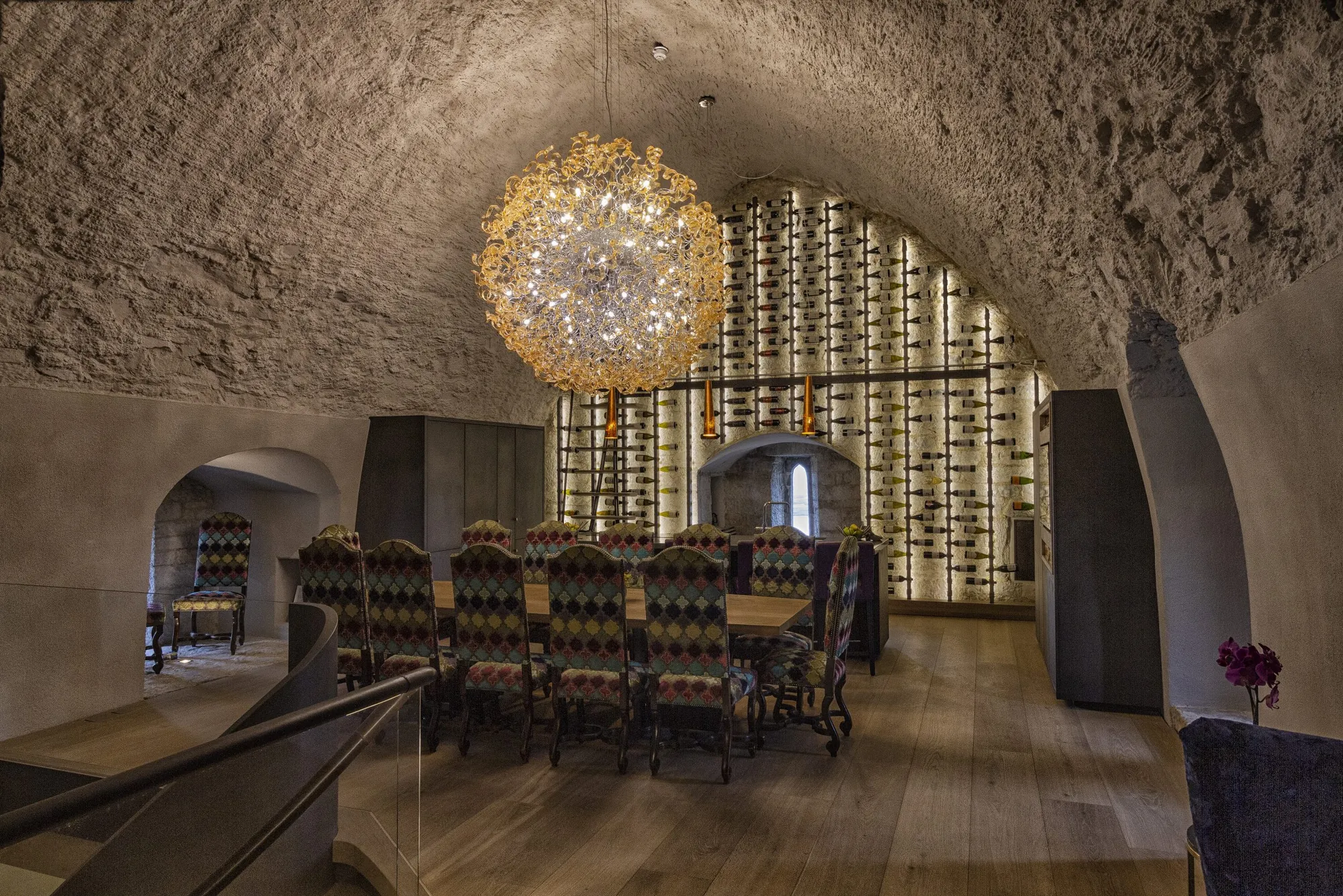 The vaulted dining room with its sunburst chandelier